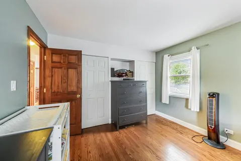 a view of a kitchen with wooden floor cabinet and a window