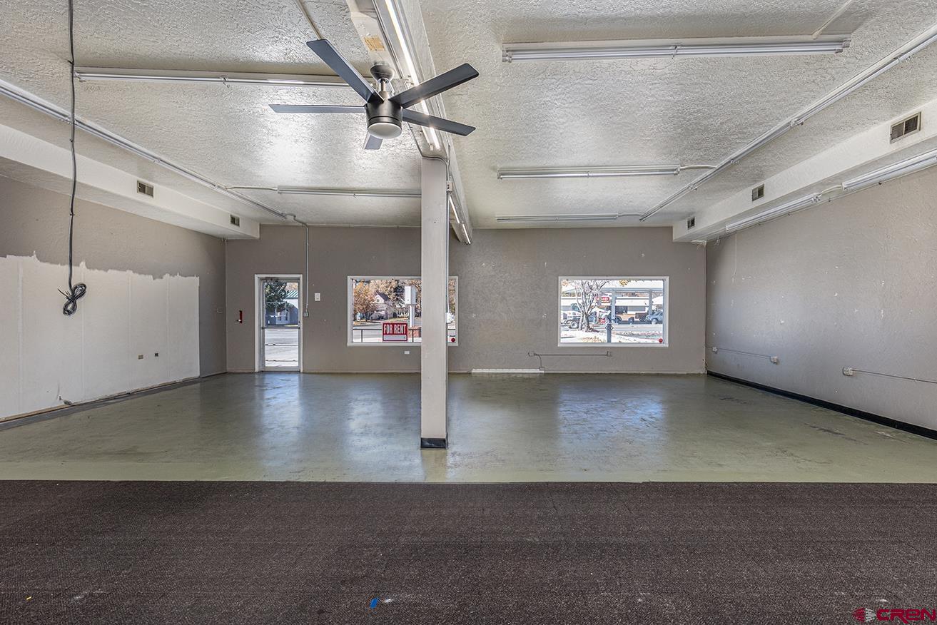 1802 Main Avenue Durango, CO 81301 - Photo 3 of 13 an empty room with windows and ceiling fan