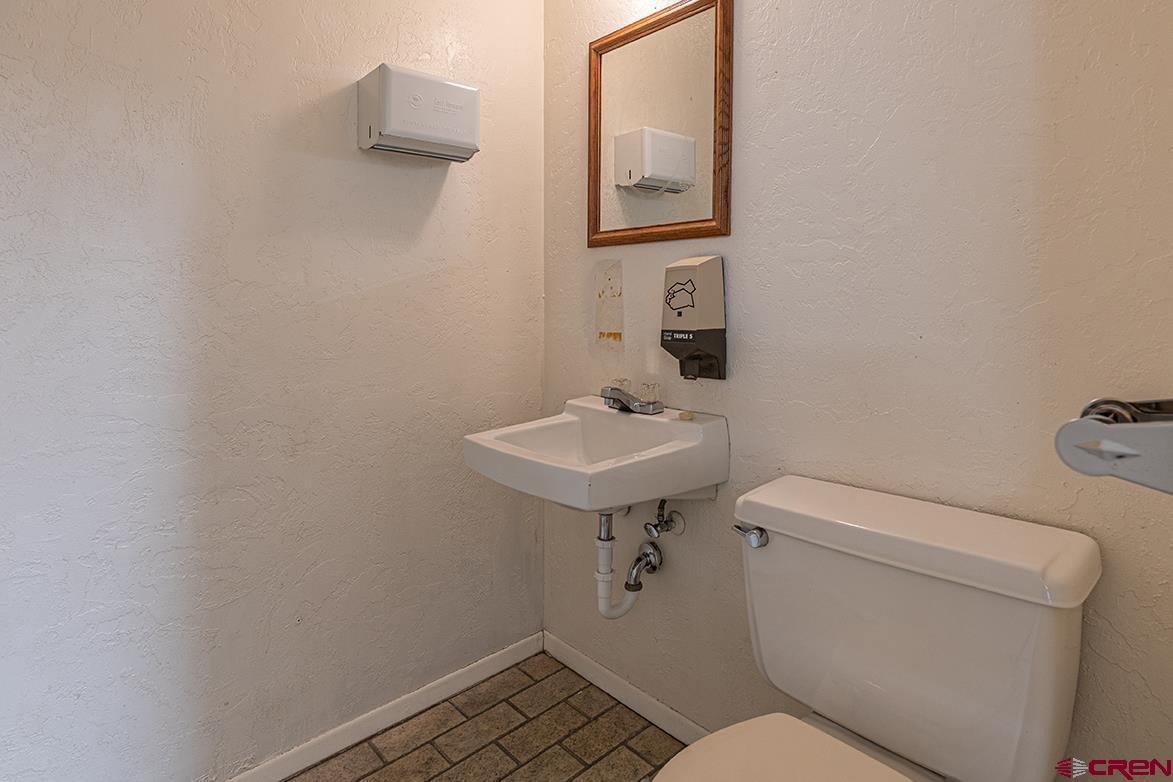 1802 Main Avenue Durango, CO 81301 - Photo 9 of 13 a bathroom with a toilet a sink and mirror
