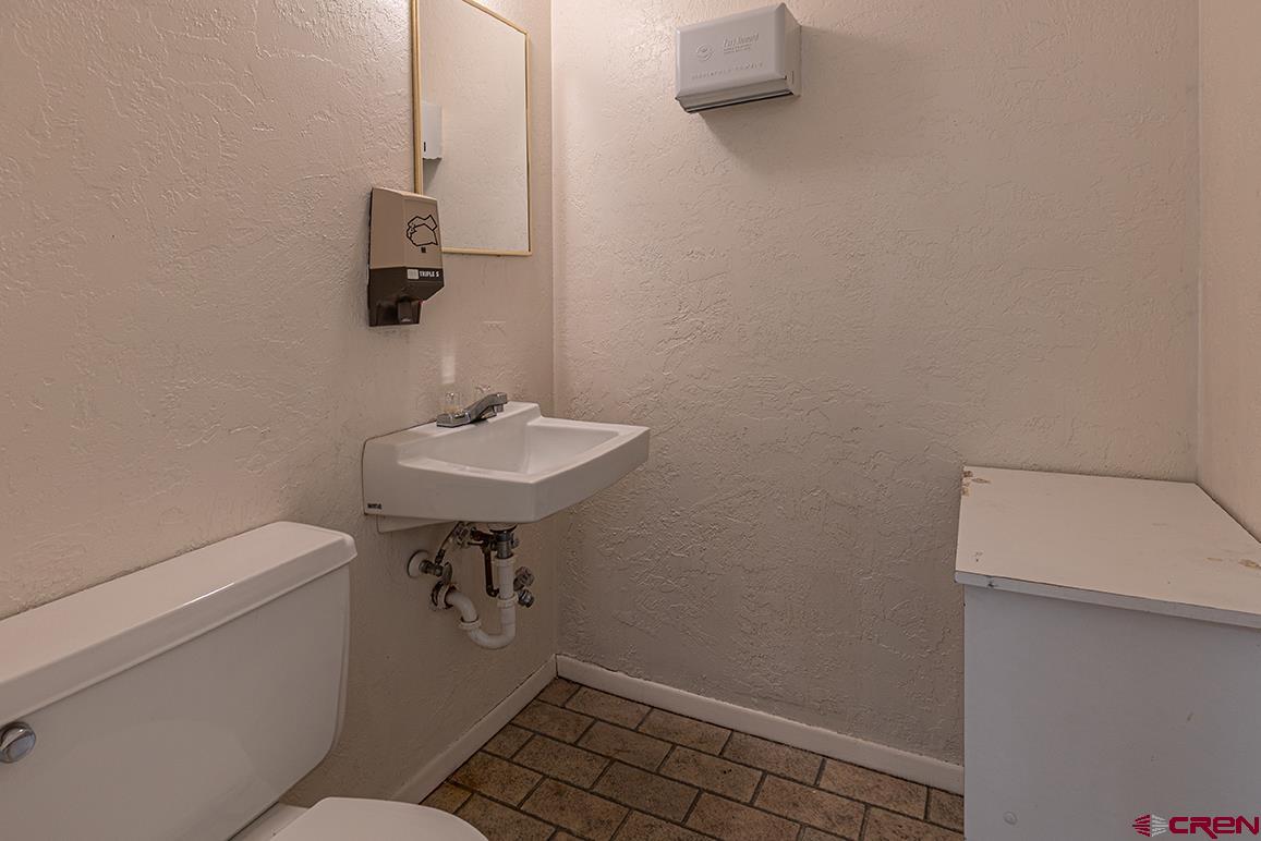 1802 Main Avenue Durango, CO 81301 - Photo 10 of 13 a bathroom with a sink a toilet and a mirror