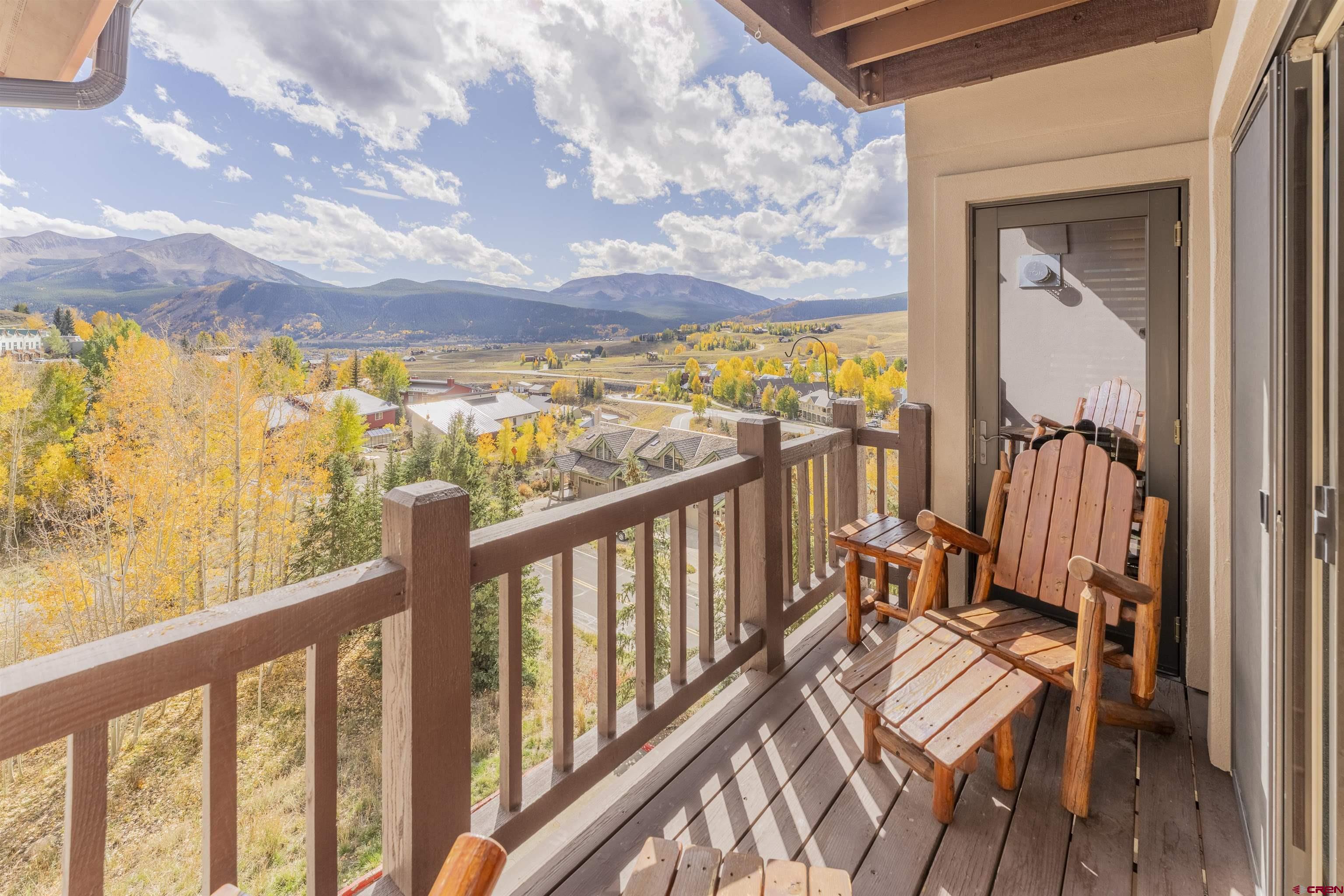 9 Hunter Hill Road, Unit 301 Crested Butte, CO 81225 - Photo 16 of 44 a view of a balcony with wooden floor and furniture