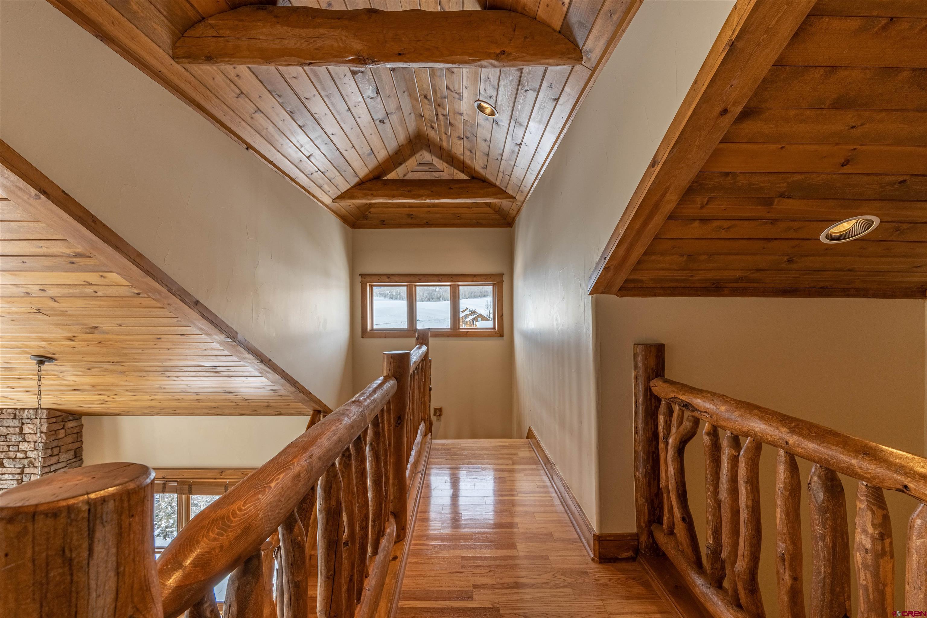 9 Hunter Hill Road, Unit 301 Crested Butte, CO 81225 - Photo 19 of 44 a view of a hallway with wooden floor and stairs