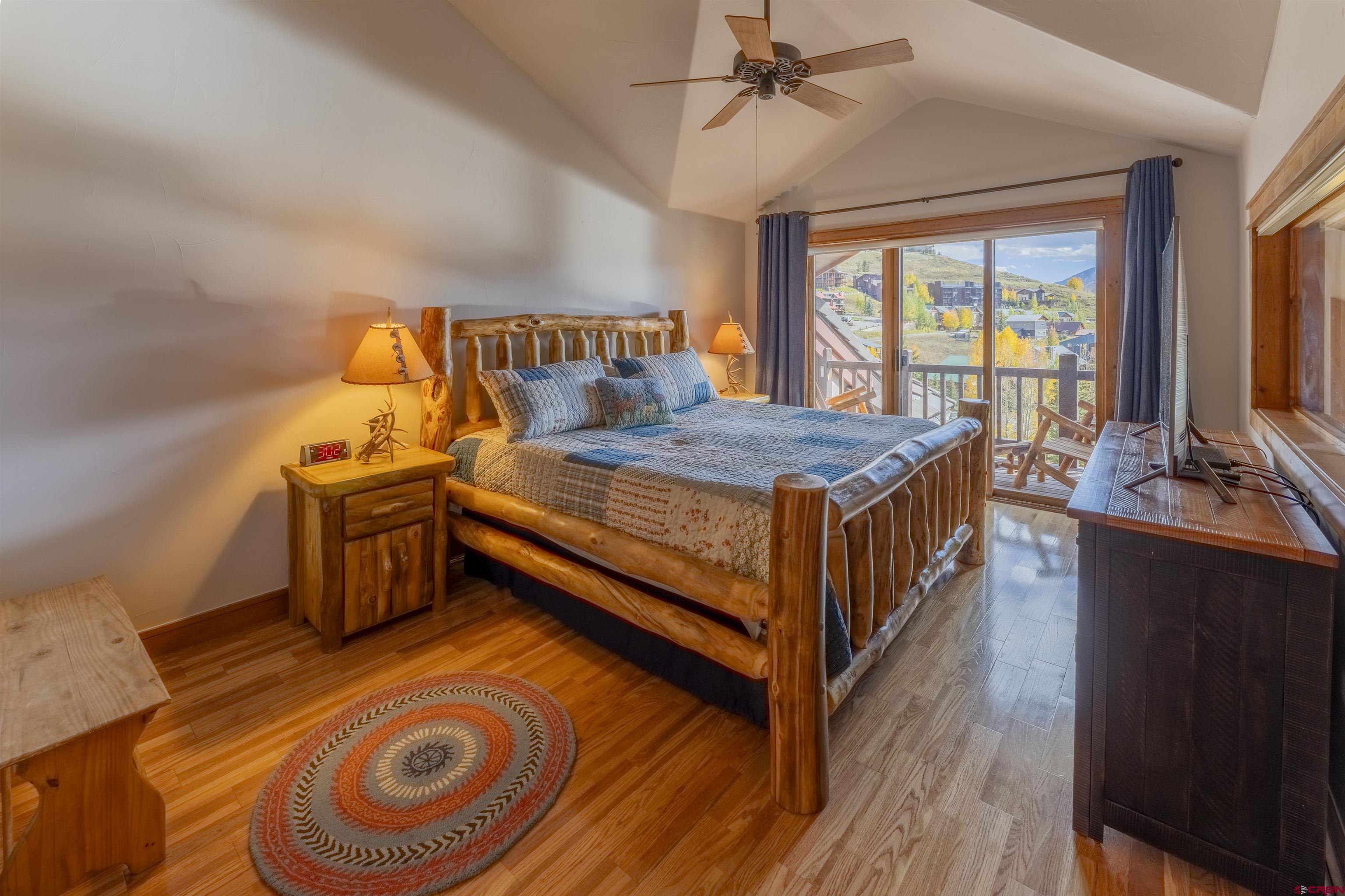 9 Hunter Hill Road, Unit 301 Crested Butte, CO 81225 - Photo 21 of 44 a bedroom with a bed and wooden floor
