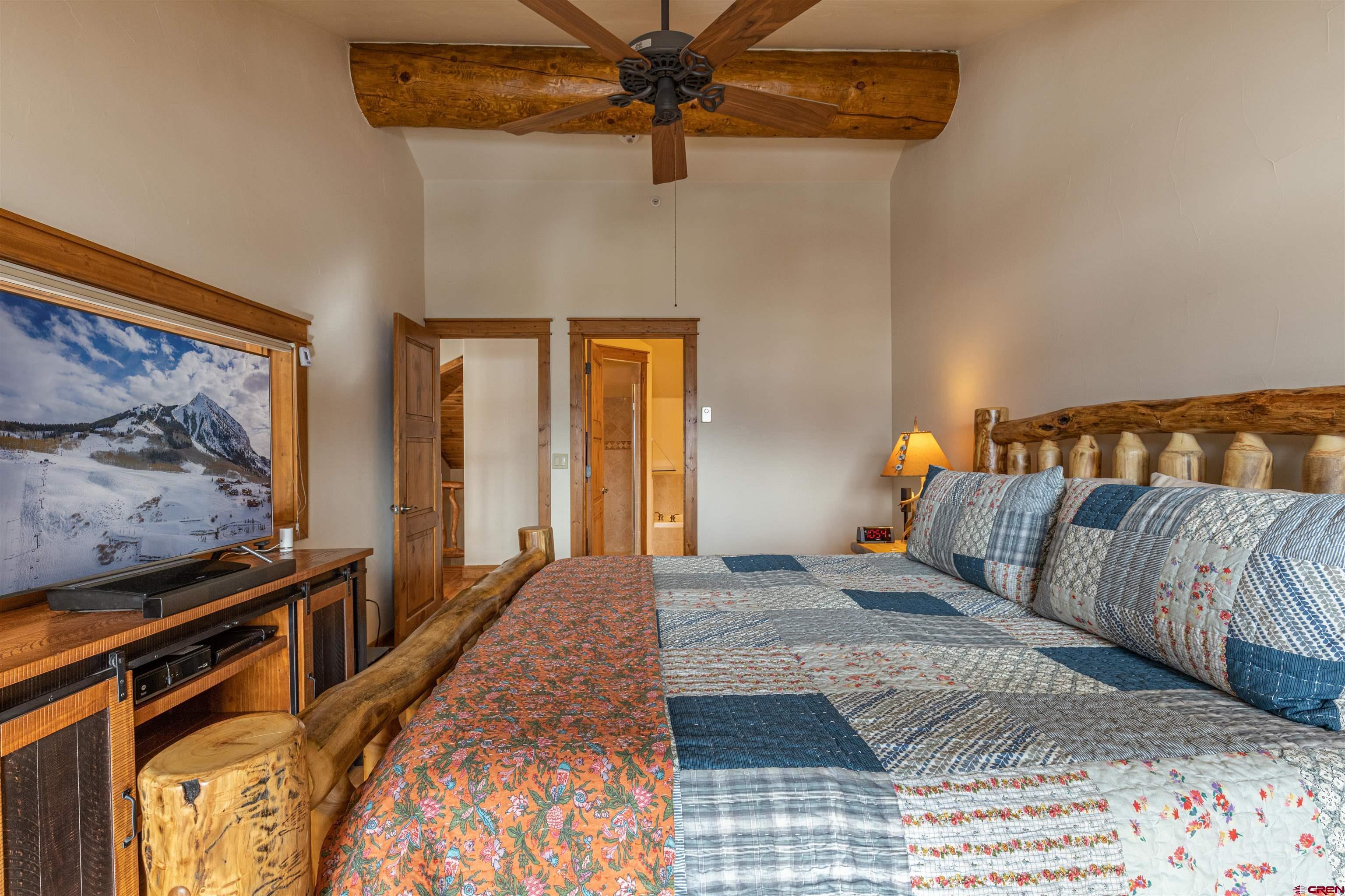 9 Hunter Hill Road, Unit 301 Crested Butte, CO 81225 - Photo 25 of 44 a bedroom with a bed and wooden floor