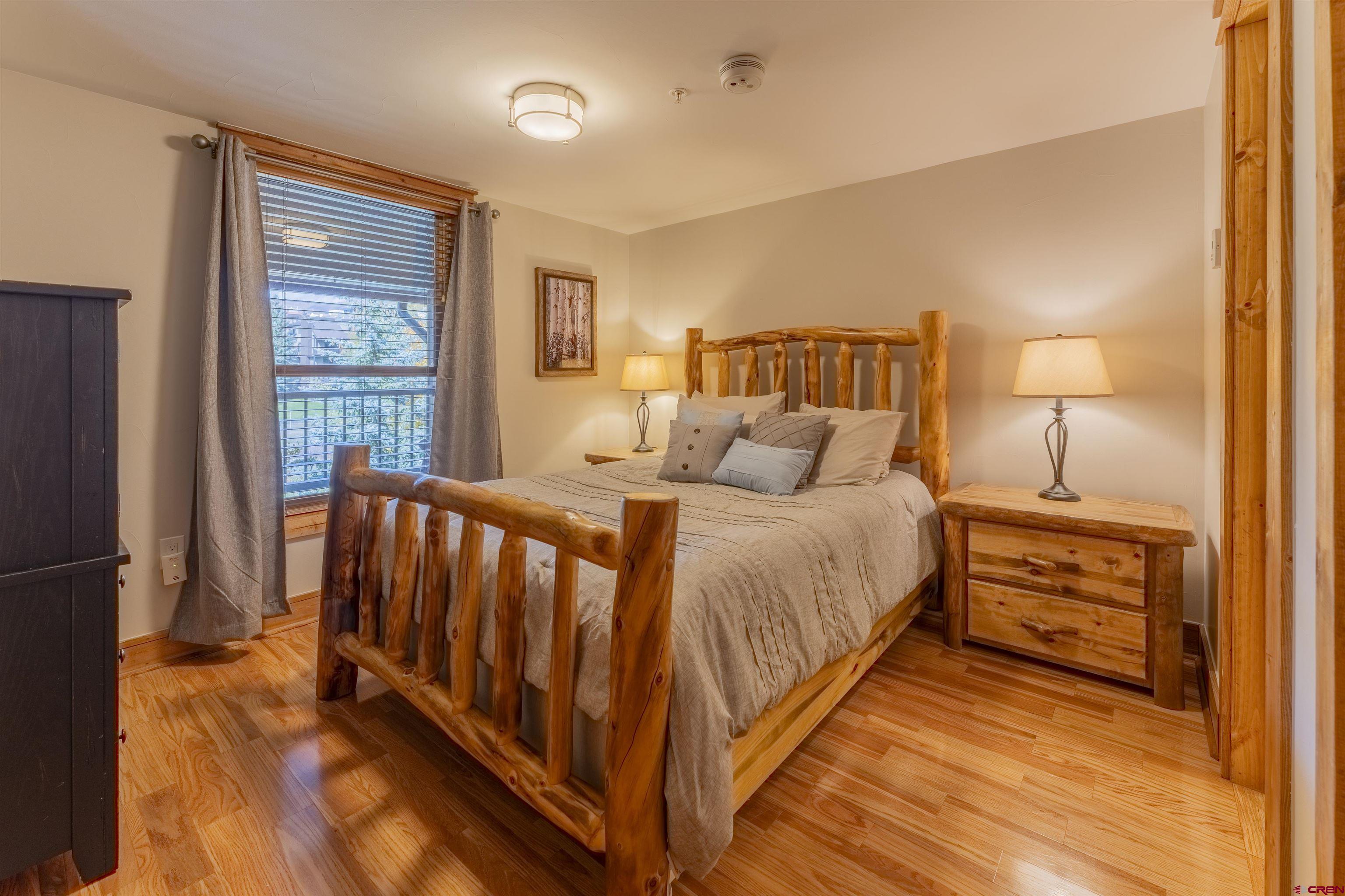 9 Hunter Hill Road, Unit 301 Crested Butte, CO 81225 - Photo 29 of 44 a bedroom with a bed and a night stand