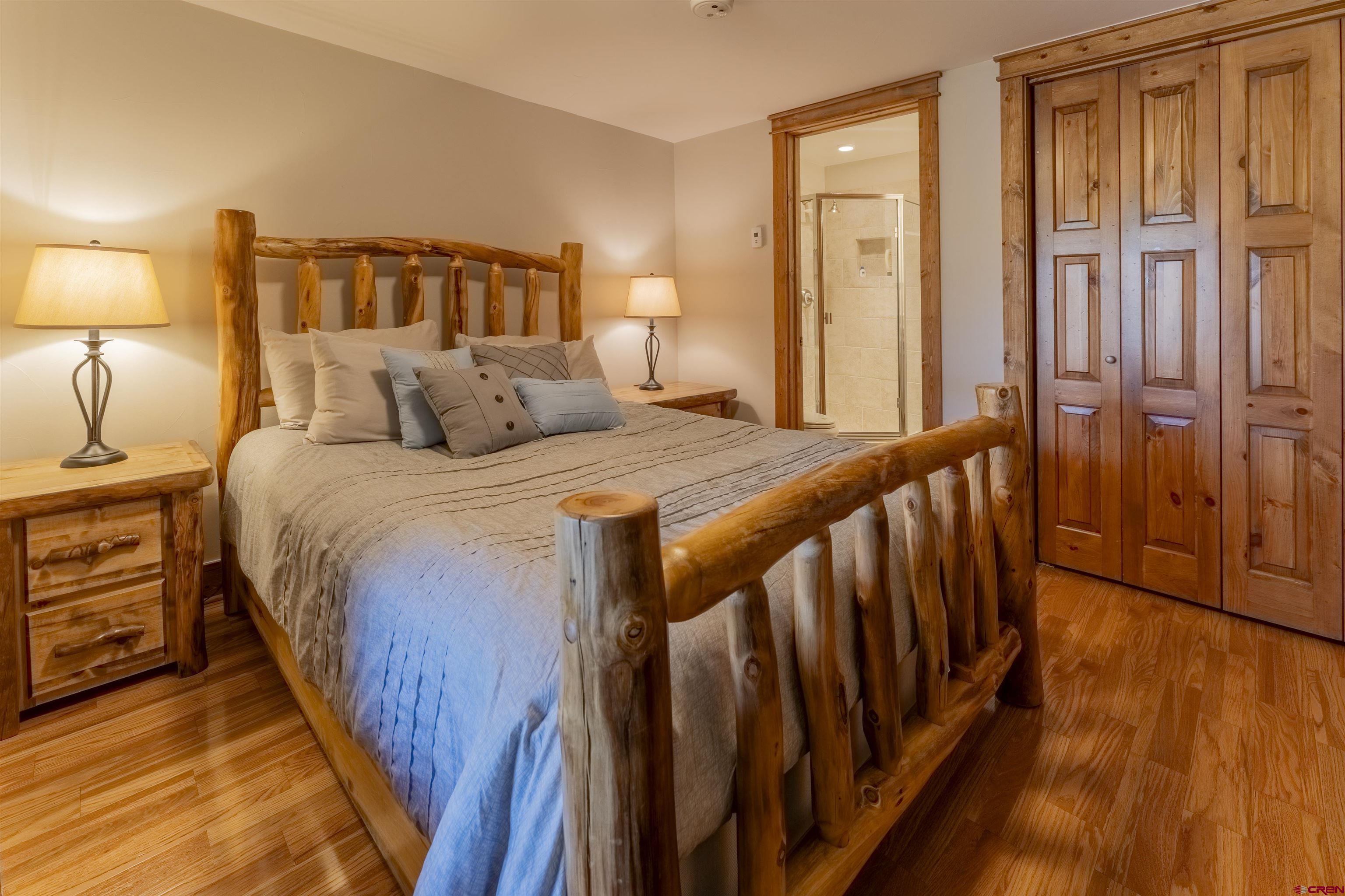 9 Hunter Hill Road, Unit 301 Crested Butte, CO 81225 - Photo 30 of 44 a bedroom with a bed and a lamp