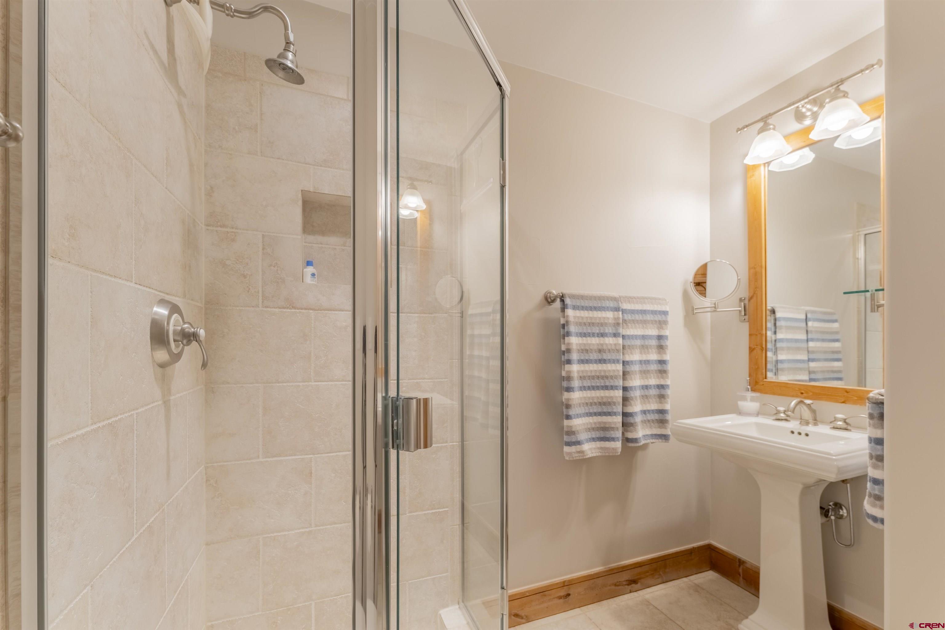 9 Hunter Hill Road, Unit 301 Crested Butte, CO 81225 - Photo 31 of 44 a bathroom with a shower and a sink