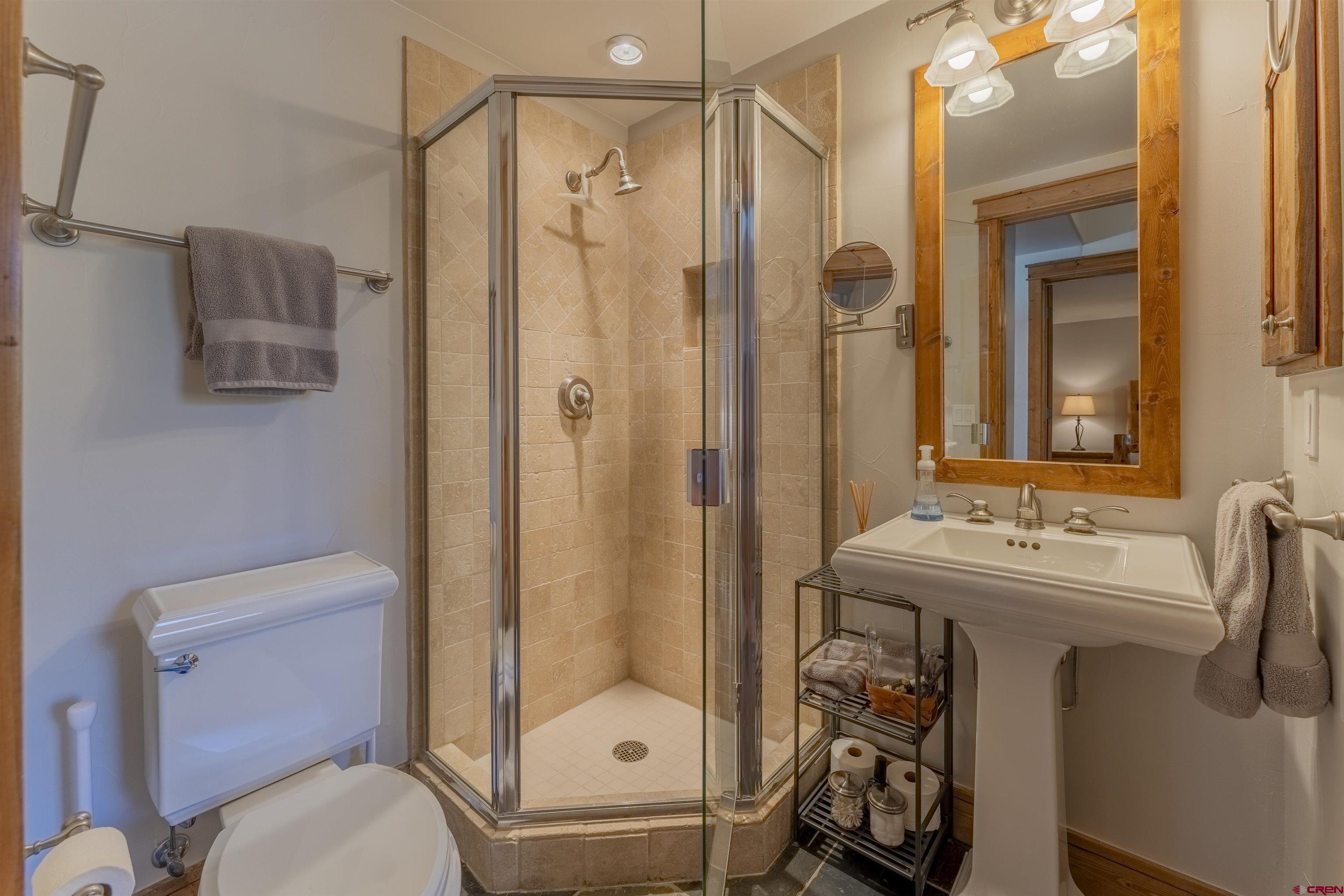 9 Hunter Hill Road, Unit 301 Crested Butte, CO 81225 - Photo 33 of 44 a bathroom with a sink toilet and shower
