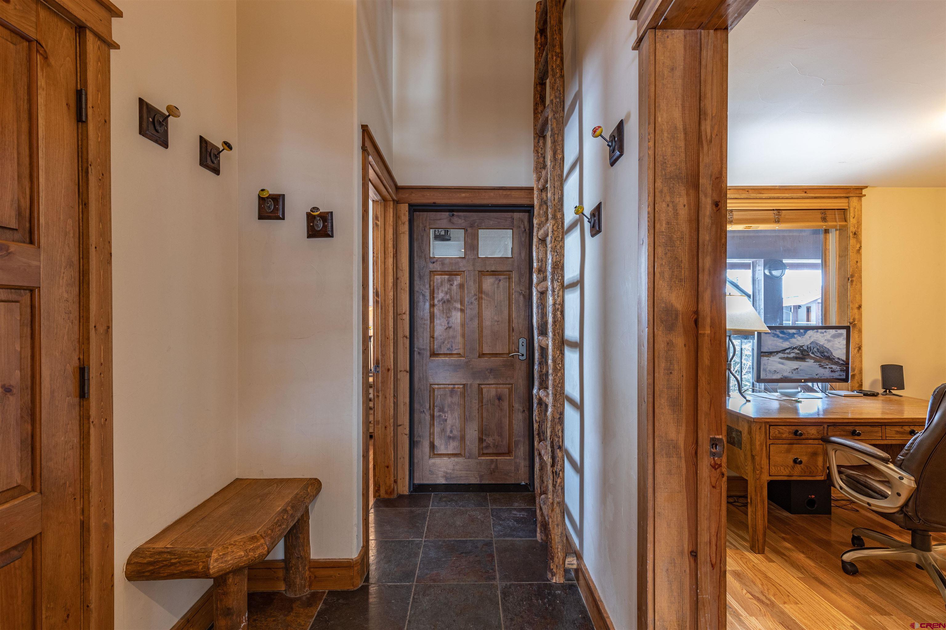 9 Hunter Hill Road, Unit 301 Crested Butte, CO 81225 - Photo 35 of 44 a view of a hallway with a livingroom and a dinning area