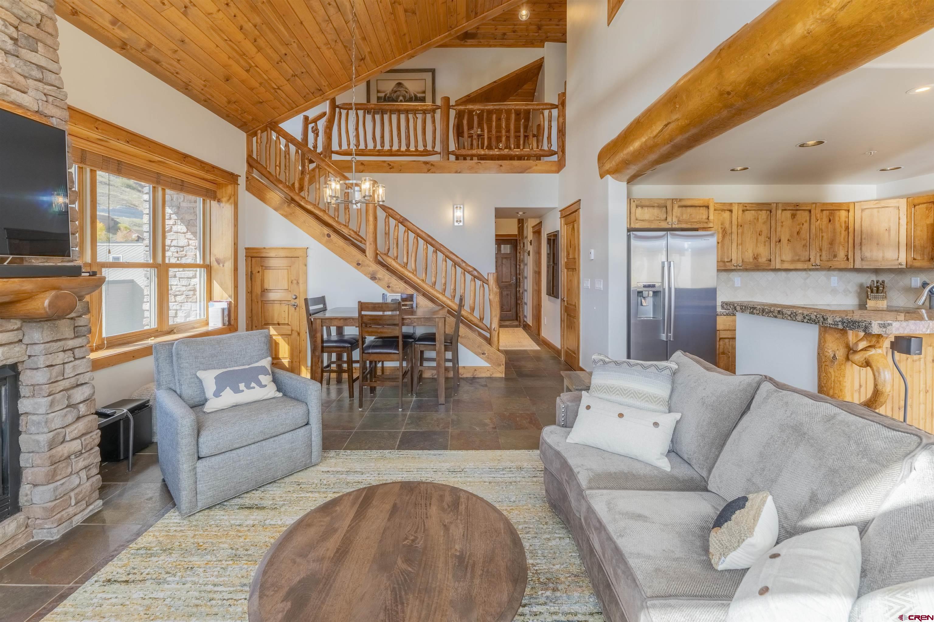 9 Hunter Hill Road, Unit 301 Crested Butte, CO 81225 - Photo 4 of 44 a living room with furniture and a large window