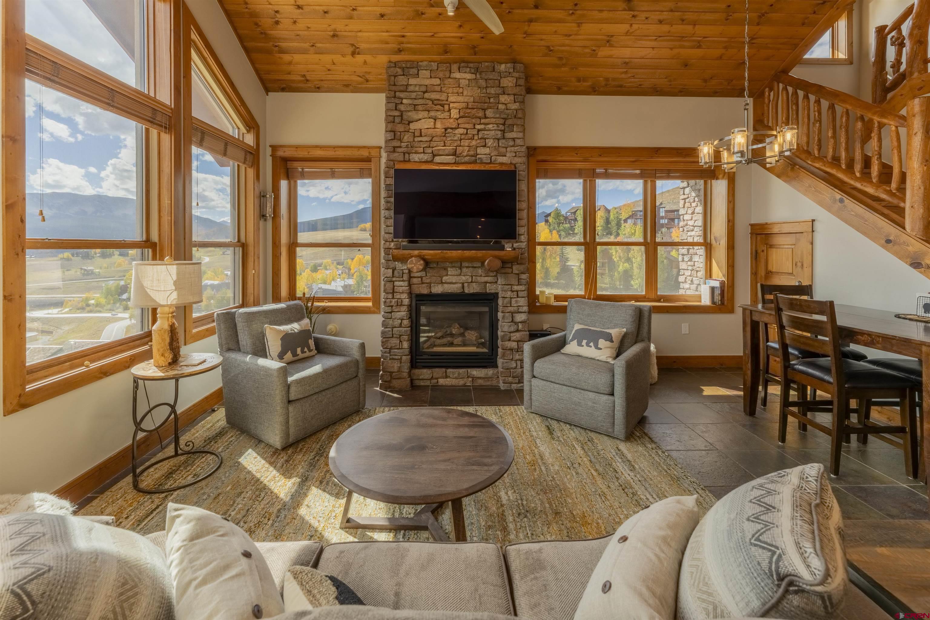 9 Hunter Hill Road, Unit 301 Crested Butte, CO 81225 - Photo 7 of 44 a living room with fireplace furniture and a flat screen tv