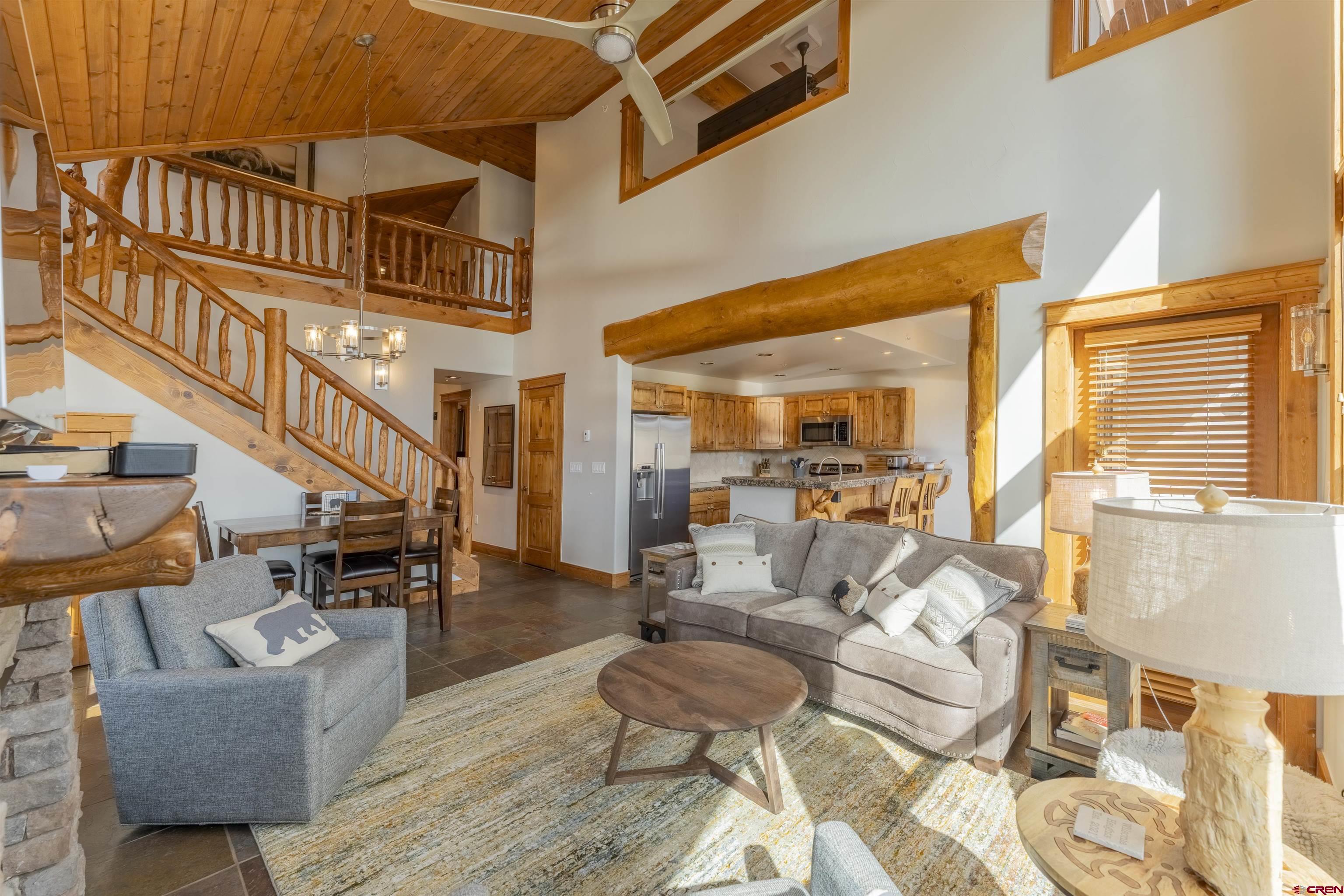 9 Hunter Hill Road, Unit 301 Crested Butte, CO 81225 - Photo 8 of 44 a living room with fireplace furniture and a large window