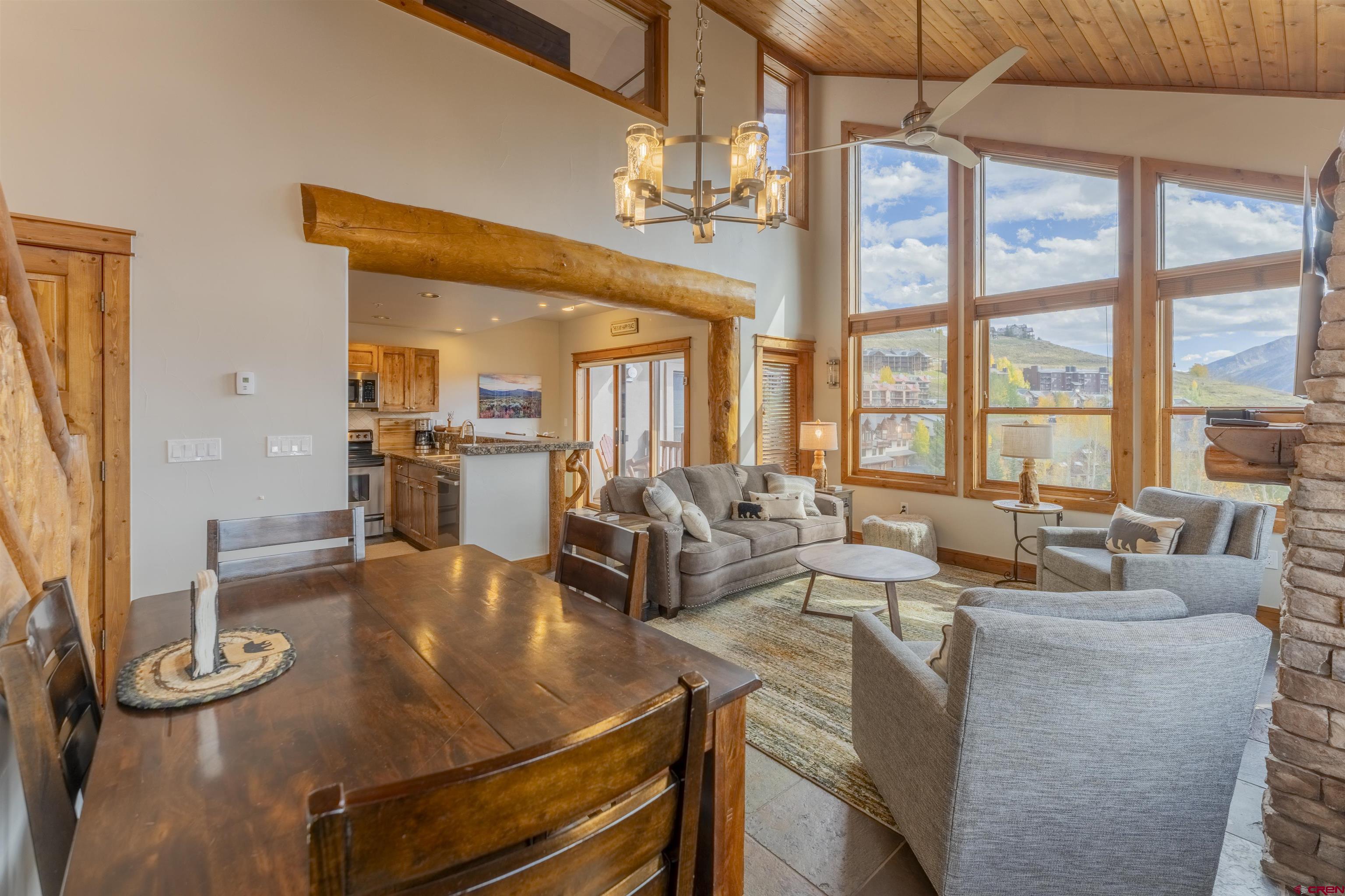 9 Hunter Hill Road, Unit 301 Crested Butte, CO 81225 - Photo 10 of 44 a living room with fireplace furniture and a large window