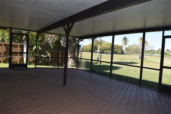 a view of a back yard from a corridor