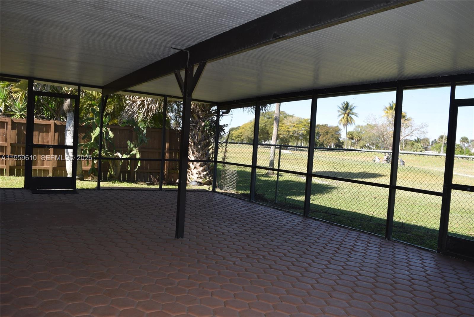 9223 Southwest 130th Street, Unit 9223 Miami, FL 33176 - Photo 11 of 12 an empty room with wooden floor and windows