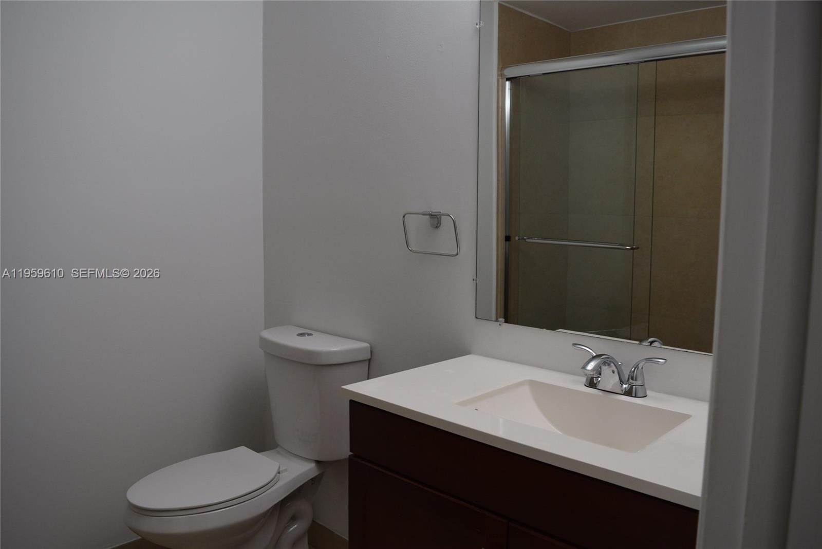 9223 Southwest 130th Street, Unit 9223 Miami, FL 33176 - Photo 7 of 12 a bathroom with a sink a toilet a mirror and vanity