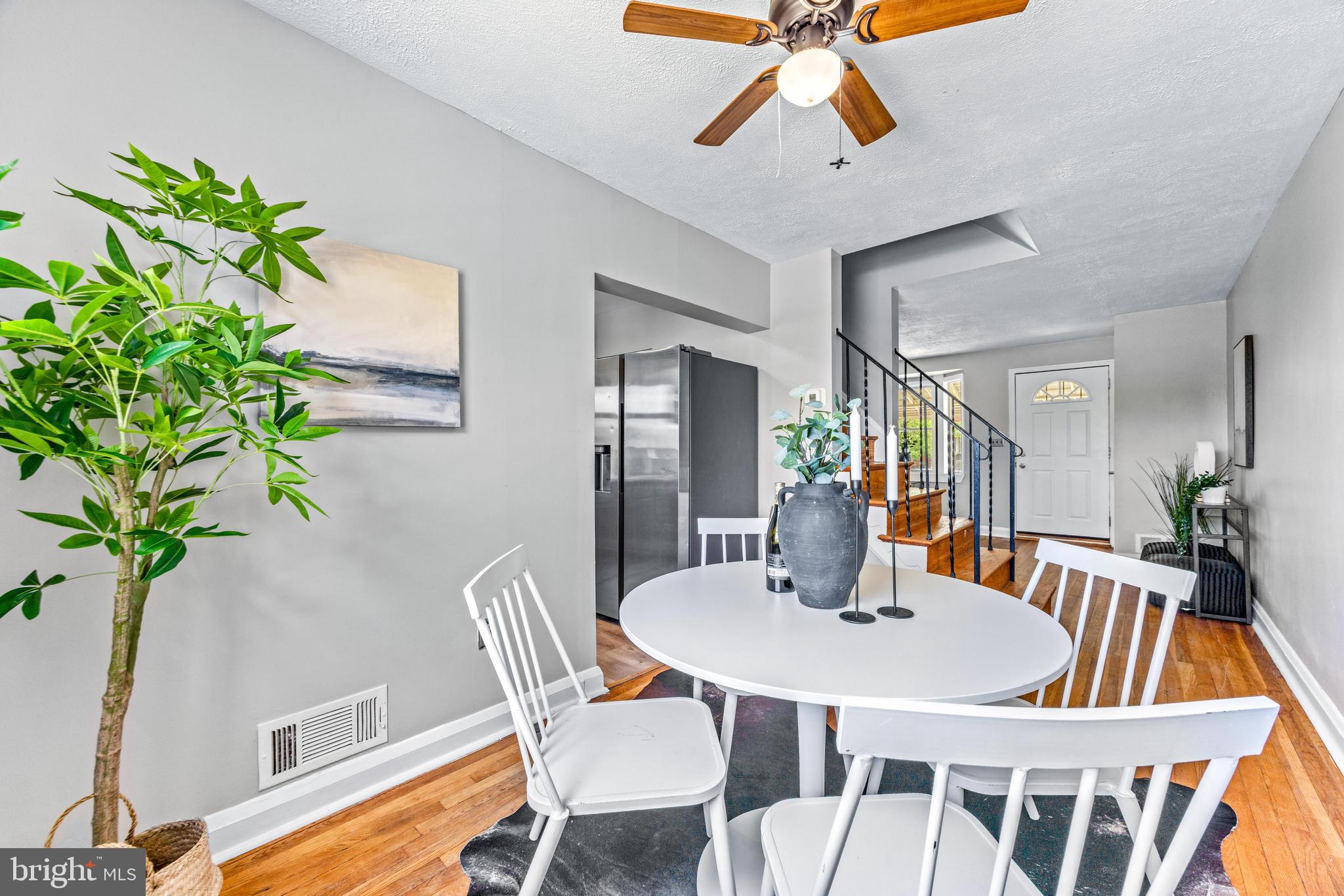 8450 Kavanagh Road Dundalk, MD 21222 - Photo 11 of 32 a dining room with furniture potted plants and wooden floor