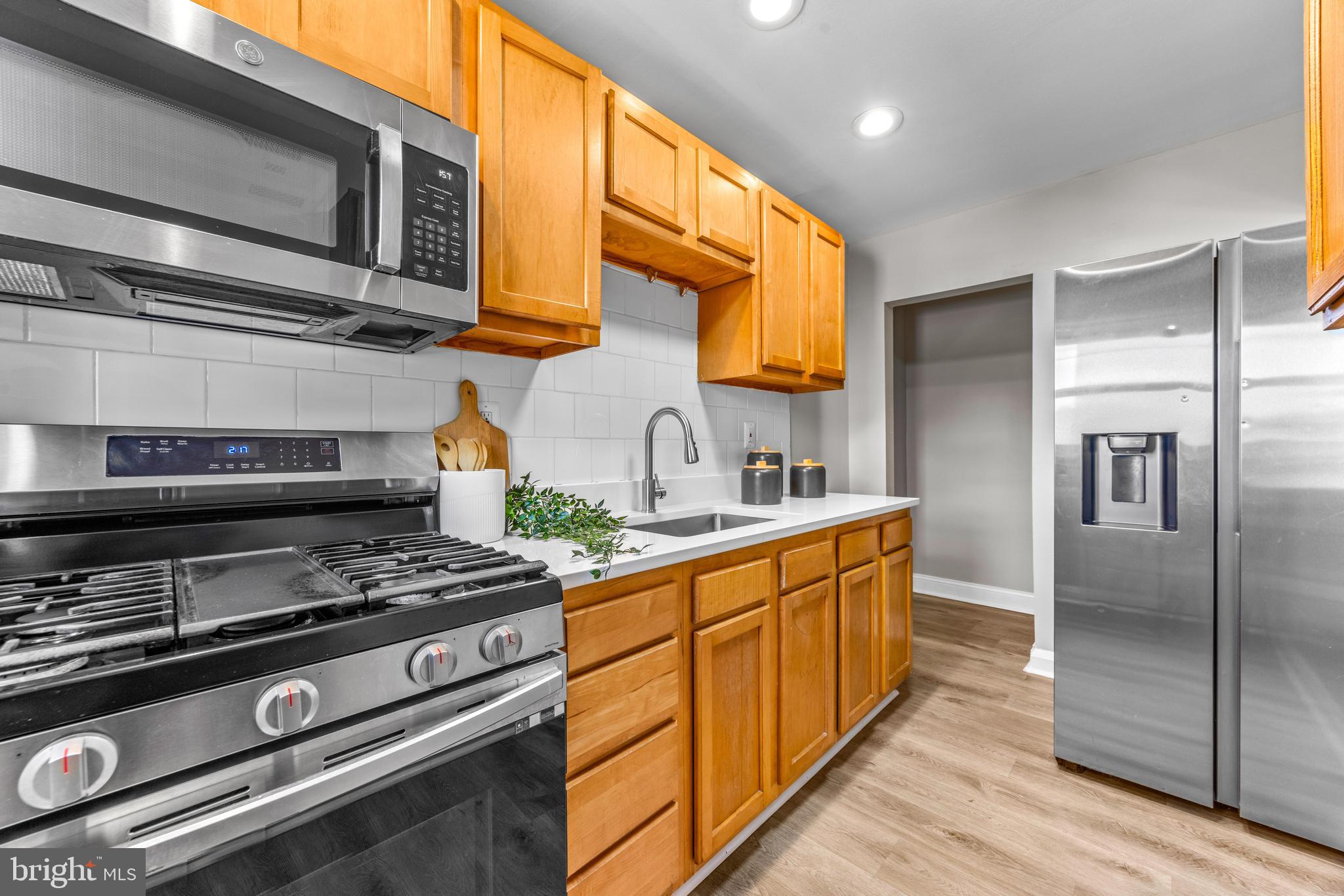 8450 Kavanagh Road Dundalk, MD 21222 - Photo 14 of 32 a kitchen with stainless steel appliances granite countertop a stove and a refrigerator