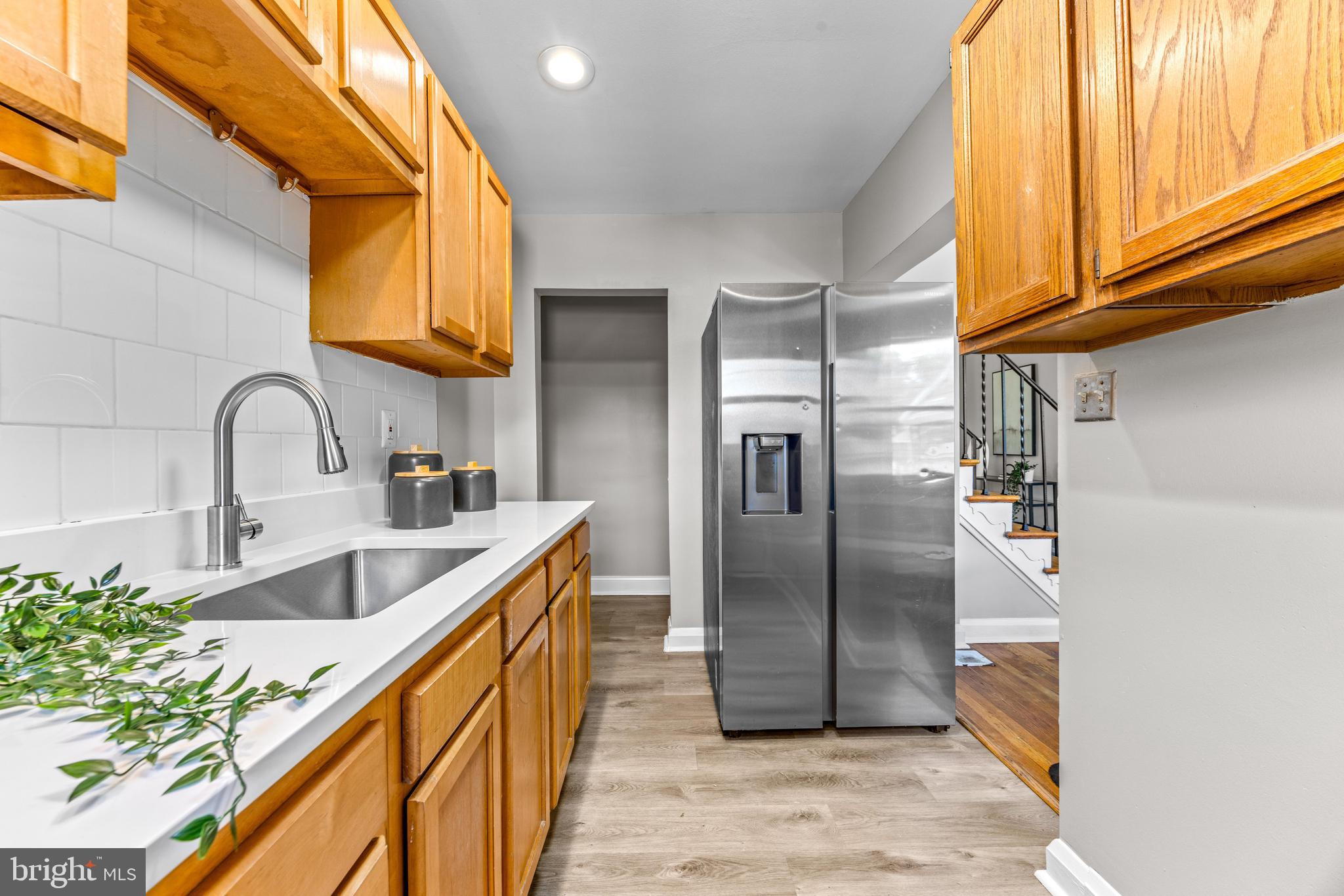 8450 Kavanagh Road Dundalk, MD 21222 - Photo 15 of 32 a kitchen with stainless steel appliances granite countertop a sink a refrigerator and a stove