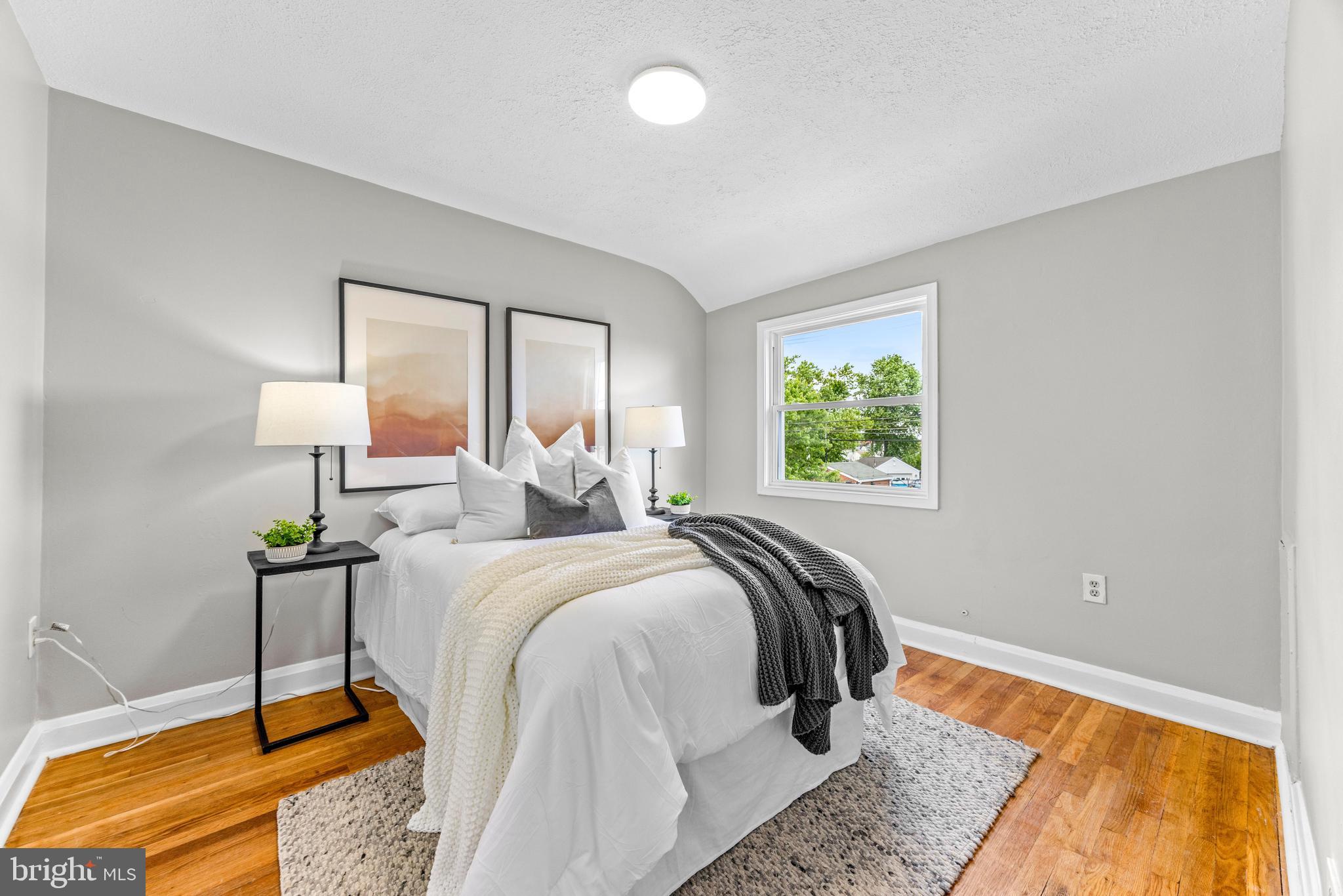 8450 Kavanagh Road Dundalk, MD 21222 - Photo 19 of 32 a bed sitting in a bedroom next to a window