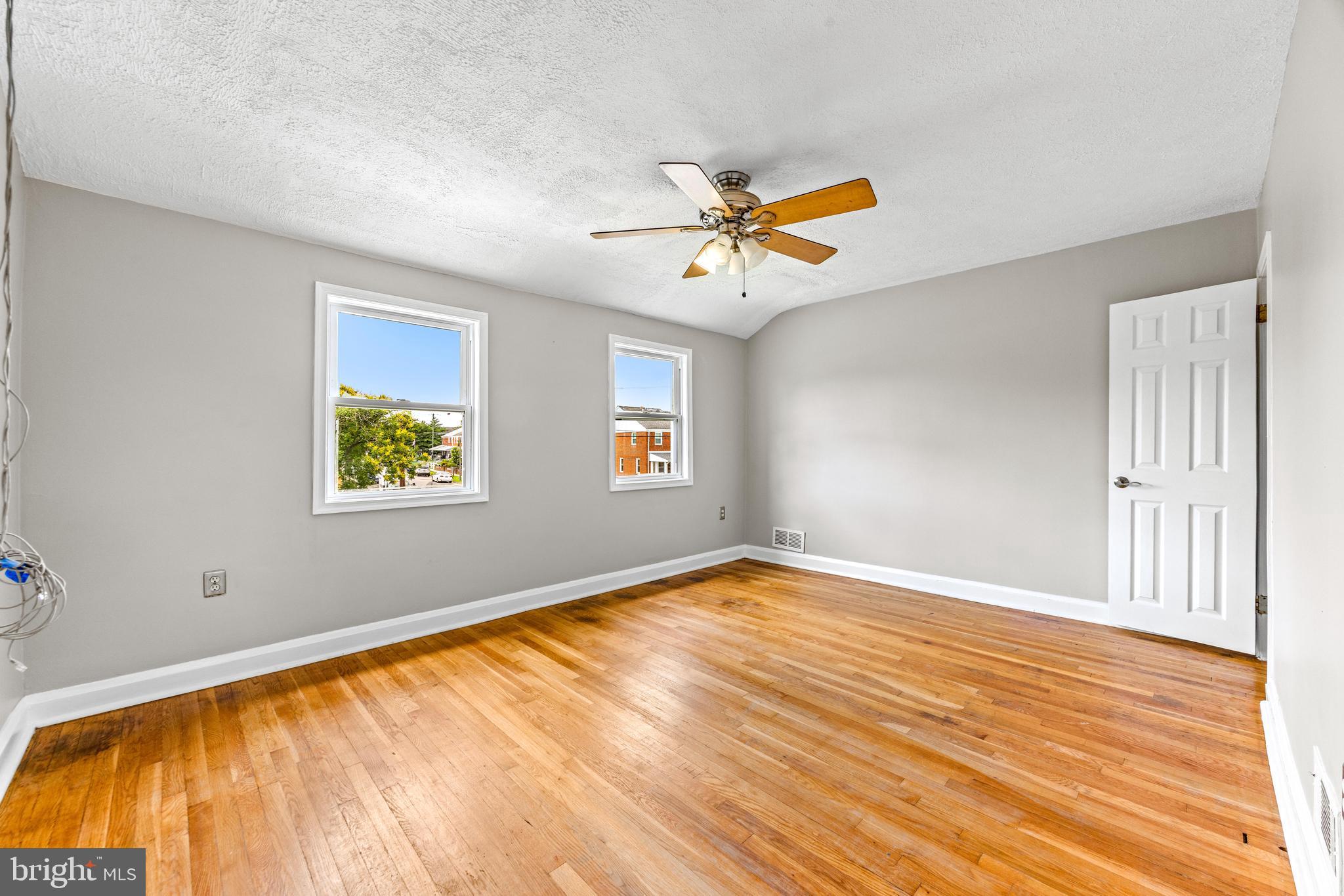 8450 Kavanagh Road Dundalk, MD 21222 - Photo 21 of 32 a view of an empty room with window and wooden floor