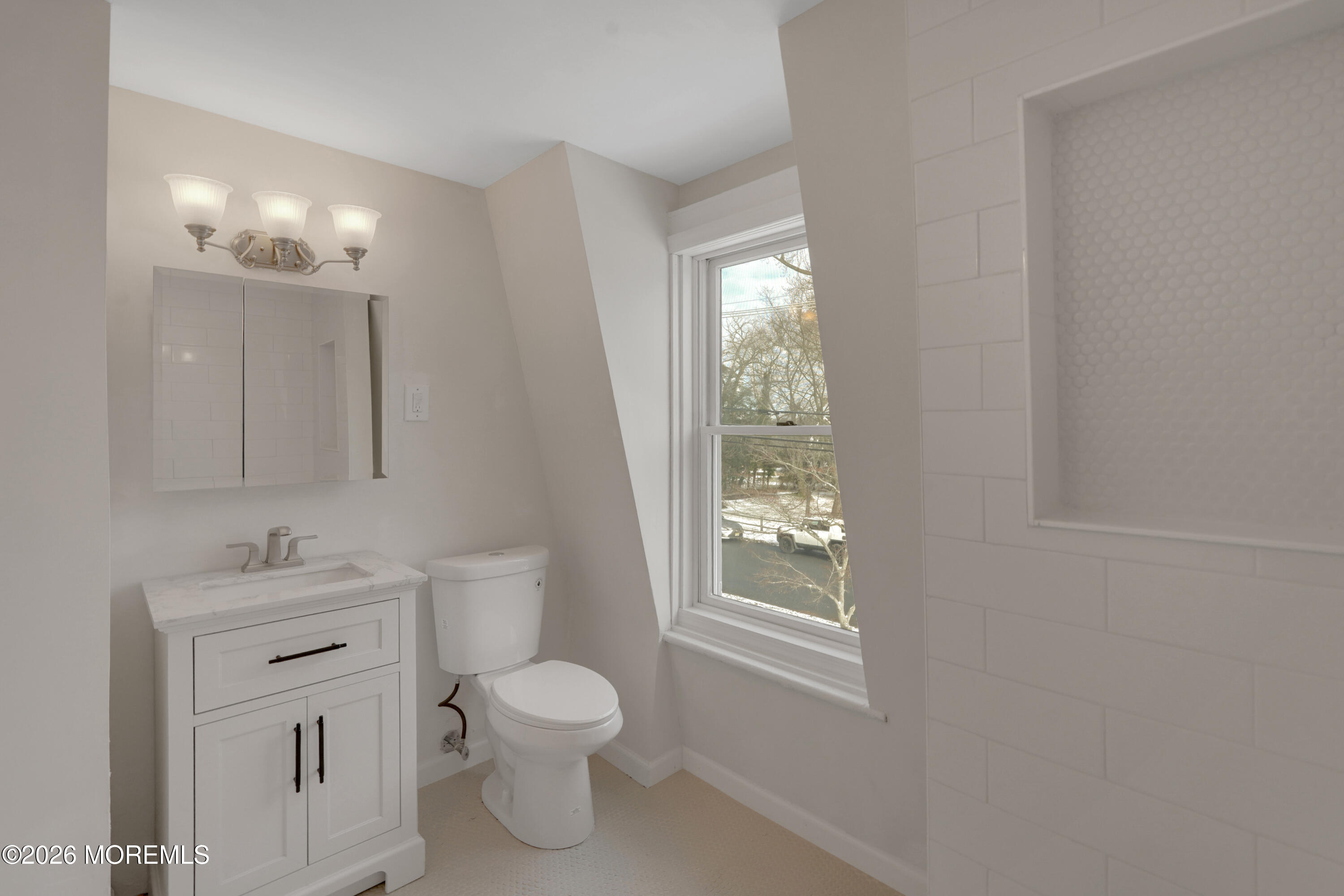 1527 Marconi Road Wall, NJ 07719 - Photo 13 of 25 a bathroom with a toilet a sink a light fixture and a window