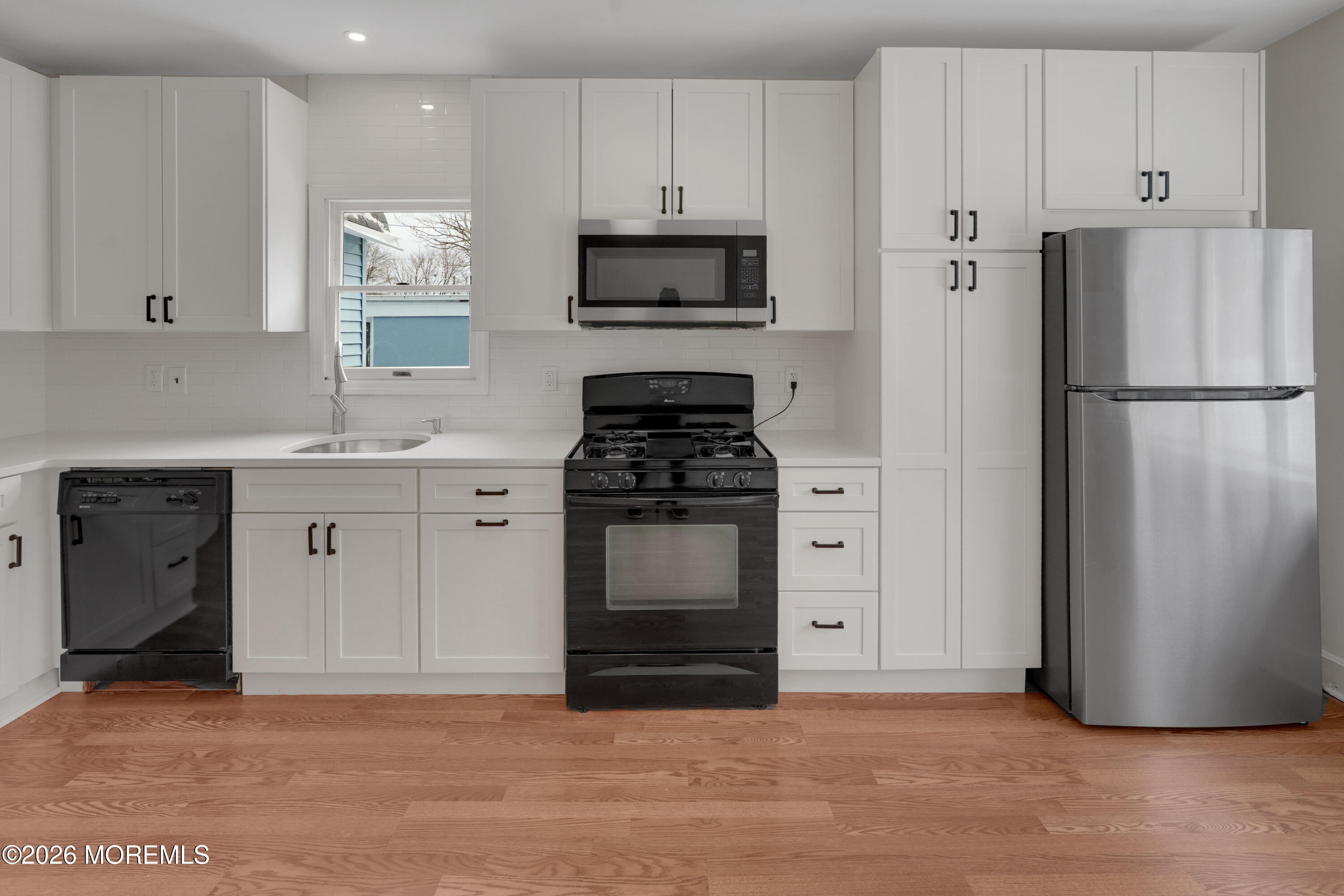 1527 Marconi Road Wall, NJ 07719 - Photo 24 of 25 a kitchen with a refrigerator sink and cabinets