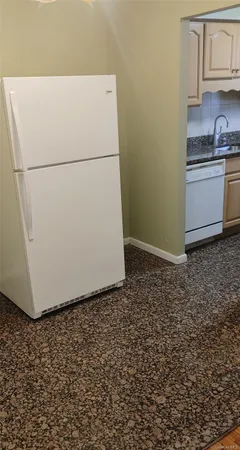 a white refrigerator freezer sitting in a kitchen