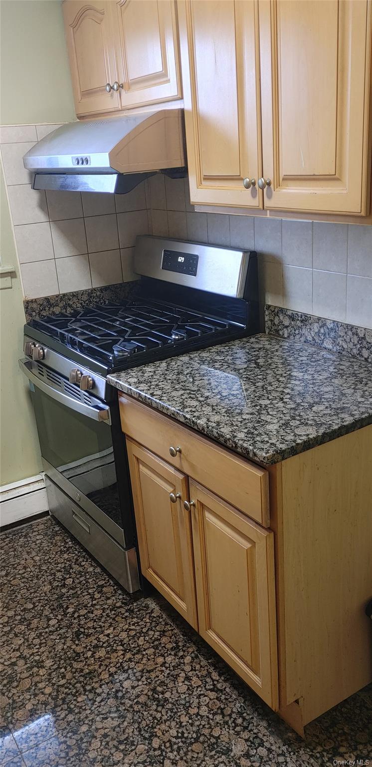 106 Union Road, Unit 3J Spring Valley, NY 10977 - Photo 3 of 11 a kitchen with granite countertop a stove a sink and white cabinets
