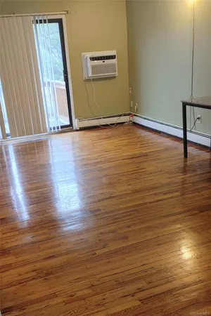 a view of room with window and wooden floor