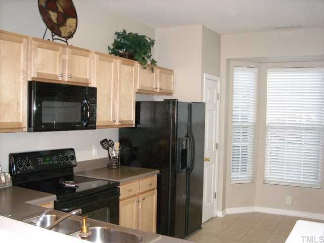 1731 Grace Brook Road Raleigh, NC 27609 - Photo 3 of 11 a kitchen with stainless steel appliances a stove a microwave and a refrigerator