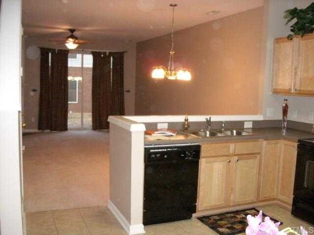 1731 Grace Brook Road Raleigh, NC 27609 - Photo 10 of 11 a kitchen with a sink and a refrigerator