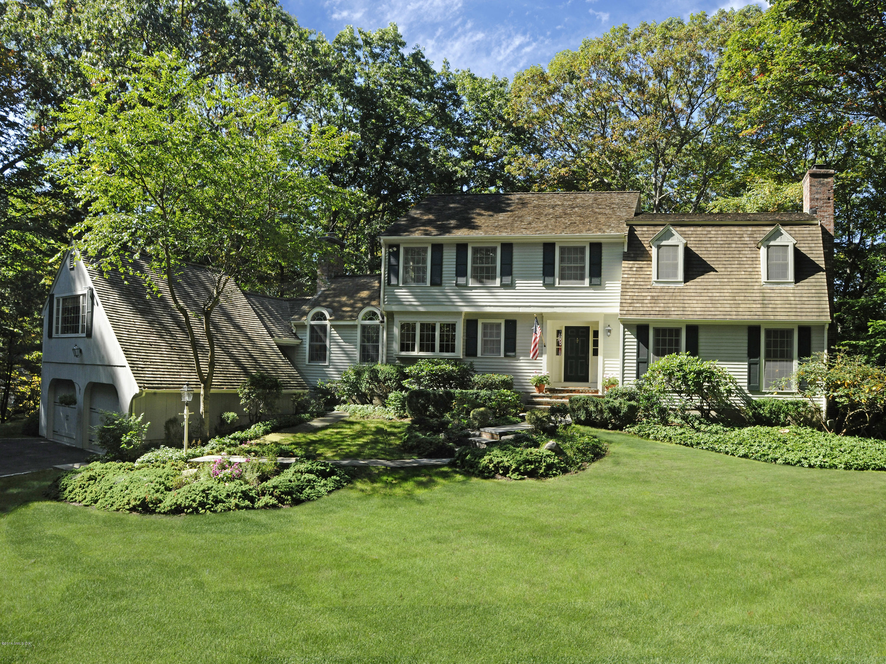 45 Old Stone Bridge Road Cos Cob, CT 06807 - Photo 1 of 35 a front view of a house with a garden