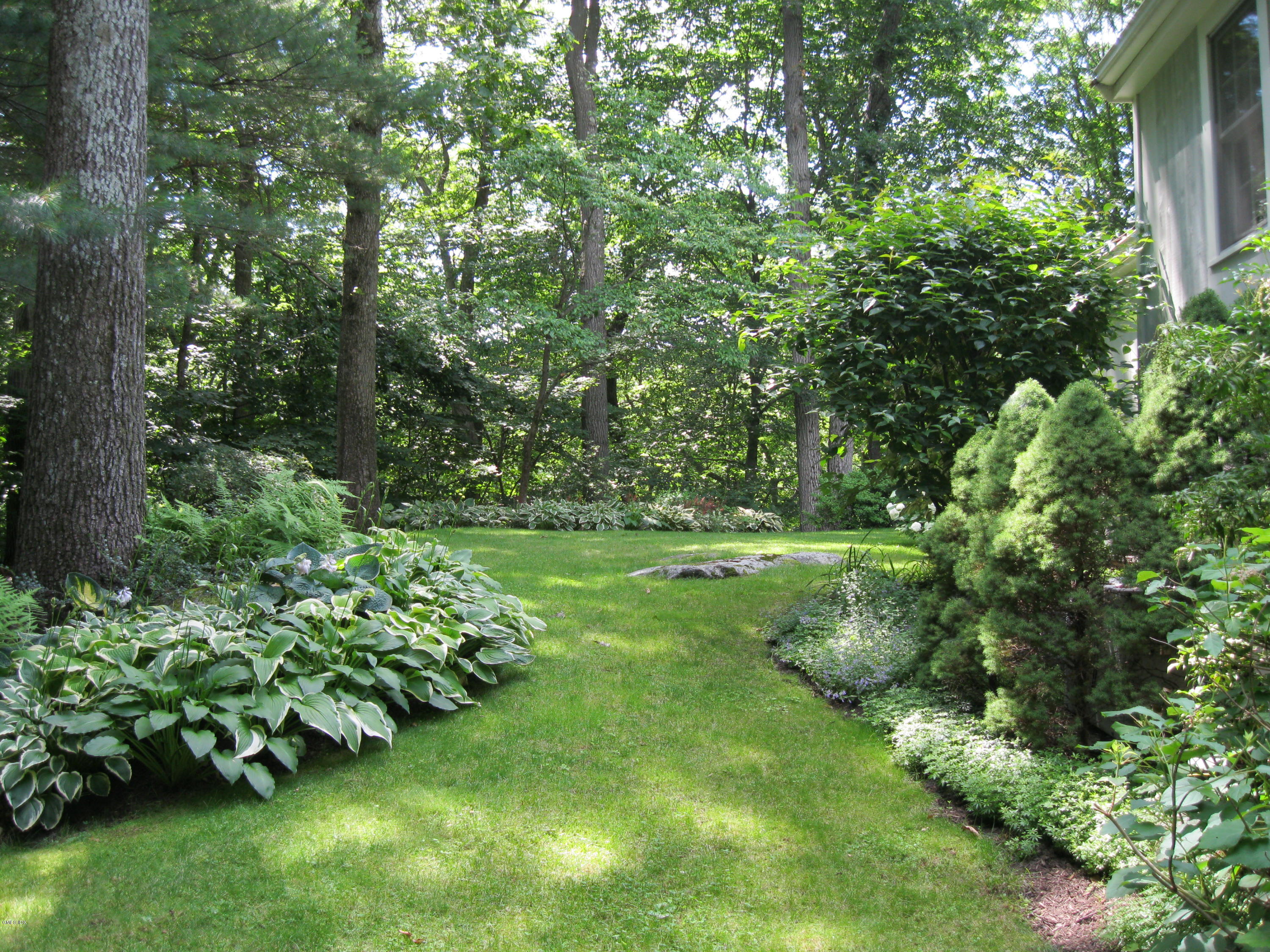 45 Old Stone Bridge Road Cos Cob, CT 06807 - Photo 30 of 35 a view of a garden with a bench