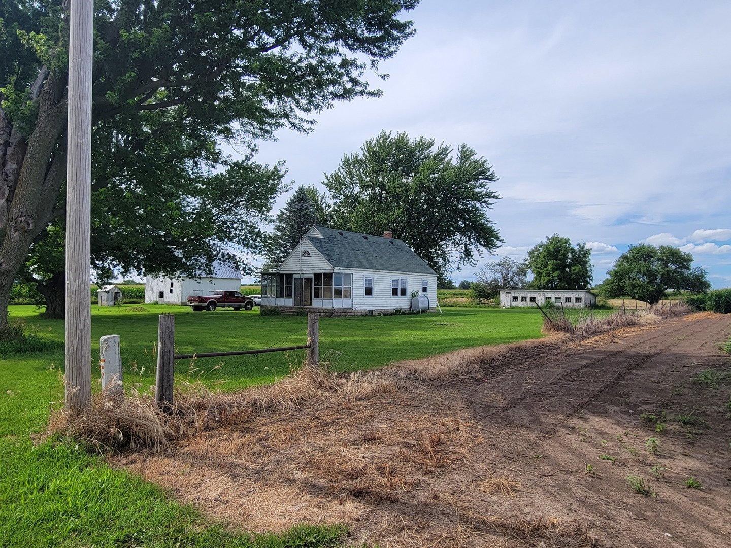 1452 Sterling Road Amboy, IL 61310 - Photo 7 of 43 a view of house with a big yard and large trees