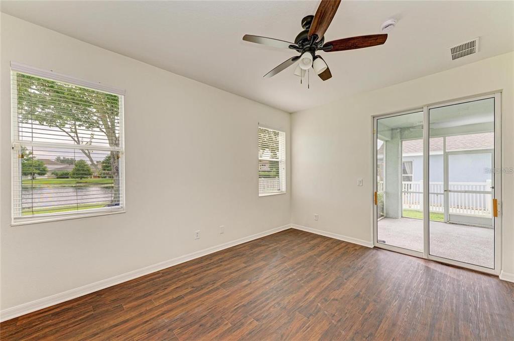 15121 Searobbin Drive Lakewood Ranch, FL 34202 - Photo 6 of 13 a view of an empty room with wooden floor and a window