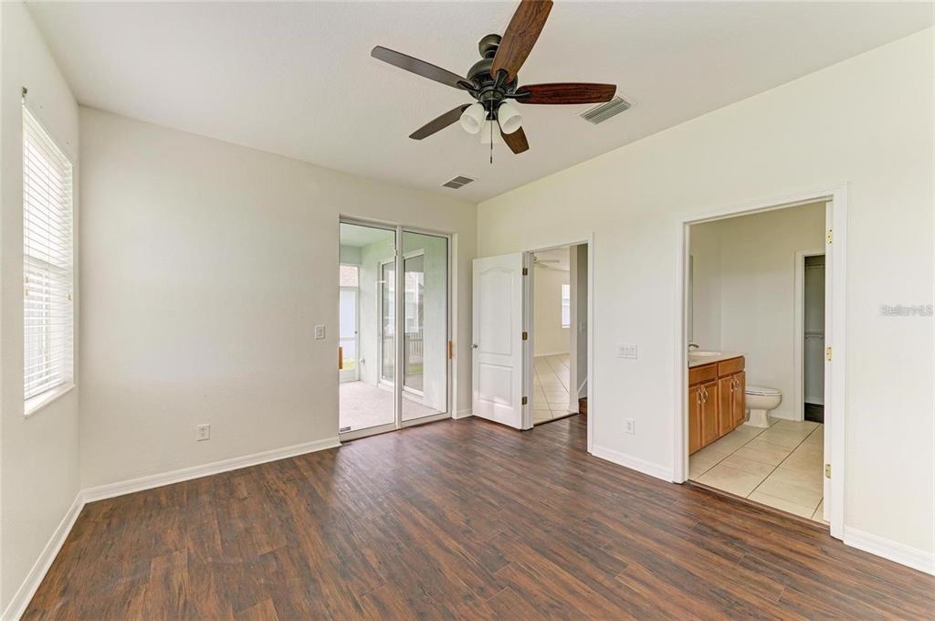 15121 Searobbin Drive Lakewood Ranch, FL 34202 - Photo 7 of 13 wooden floor in an empty room with a window