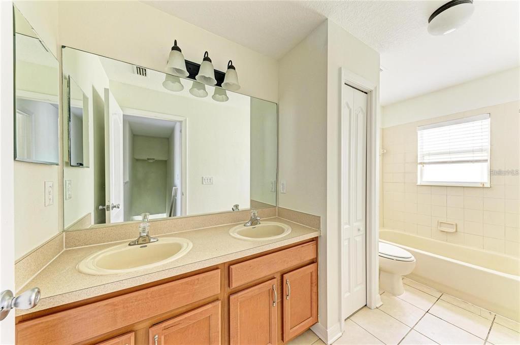 15121 Searobbin Drive Lakewood Ranch, FL 34202 - Photo 10 of 13 a bathroom with a granite countertop sink and a mirror
