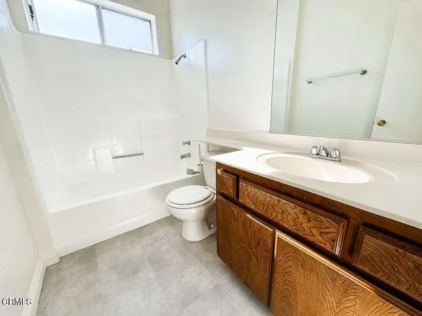 a spacious bathroom with a sink a toilet and shower