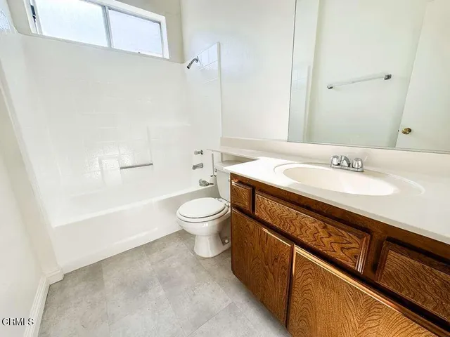 a spacious bathroom with a sink a toilet and shower