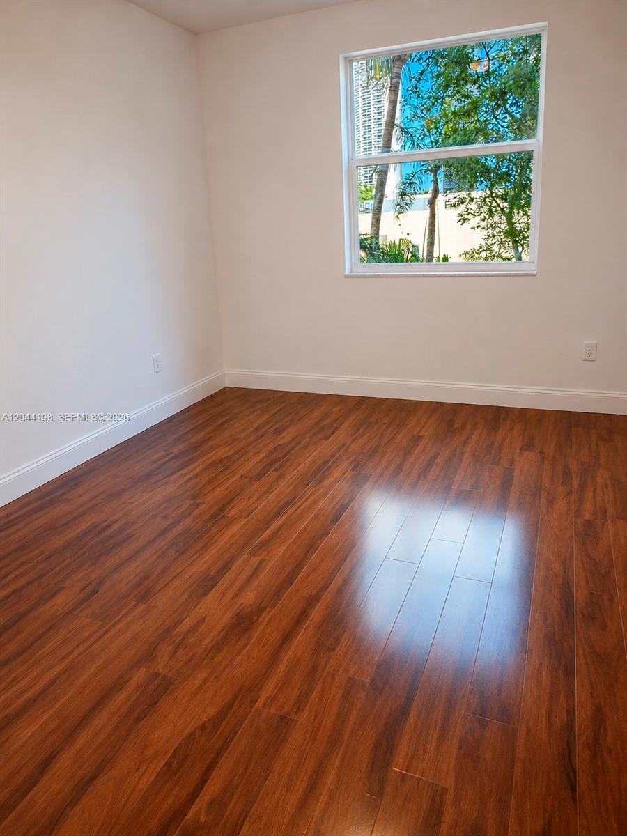 17145 North Bay Road, Unit 4307 Sunny Isles Beach, FL 33160 - Photo 9 of 35 a view of an empty room and wooden floor