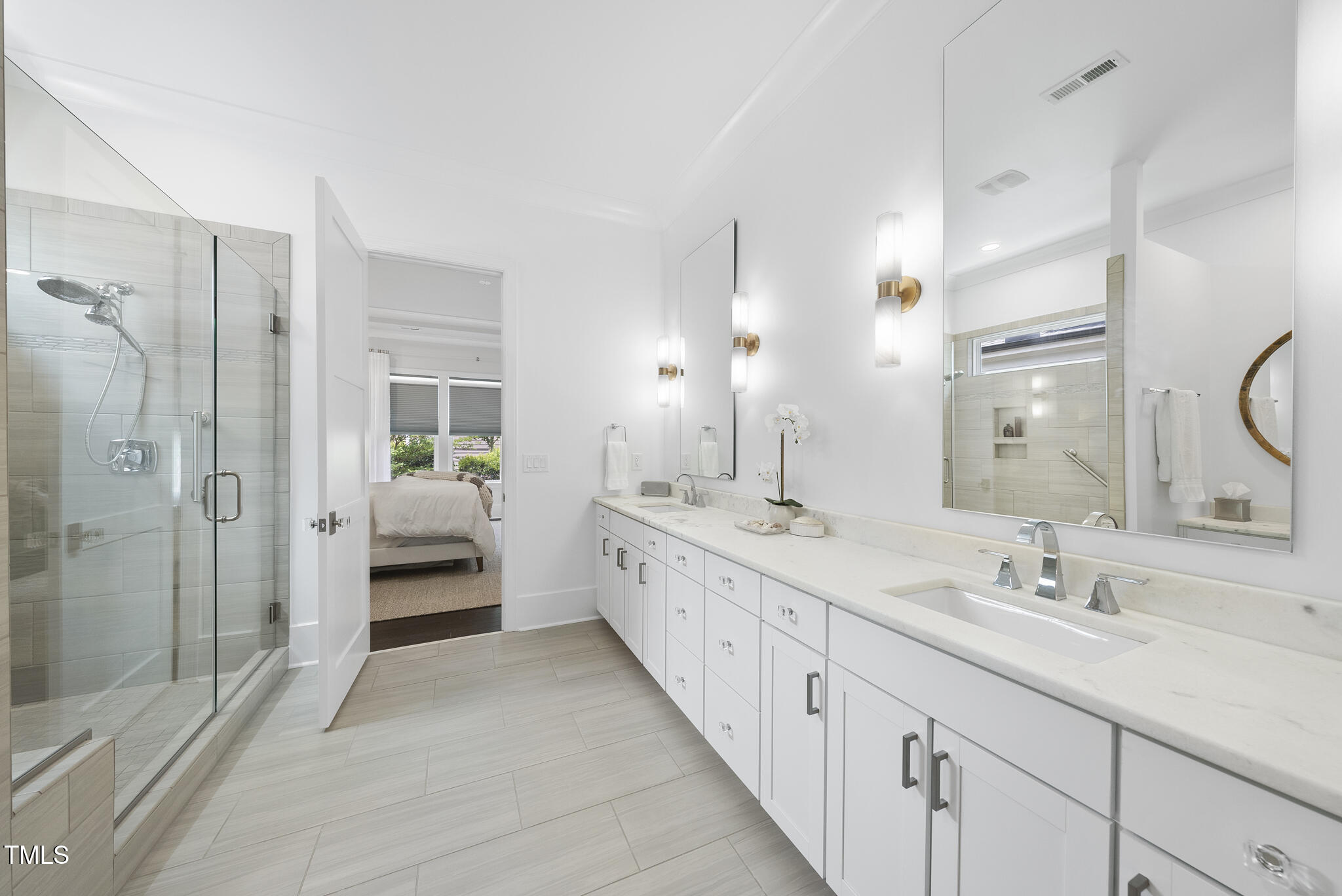 129 Damsire Way Cary, NC 27513 - Photo 19 of 33 a spacious bathroom with a double vanity sink a mirror a shower and a bathtub