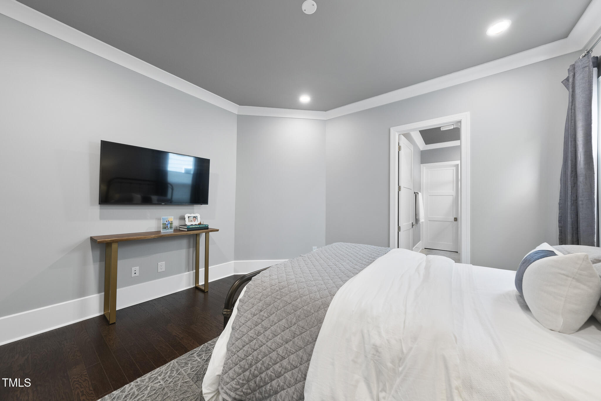 129 Damsire Way Cary, NC 27513 - Photo 25 of 33 a bedroom with a bed and a flat screen tv