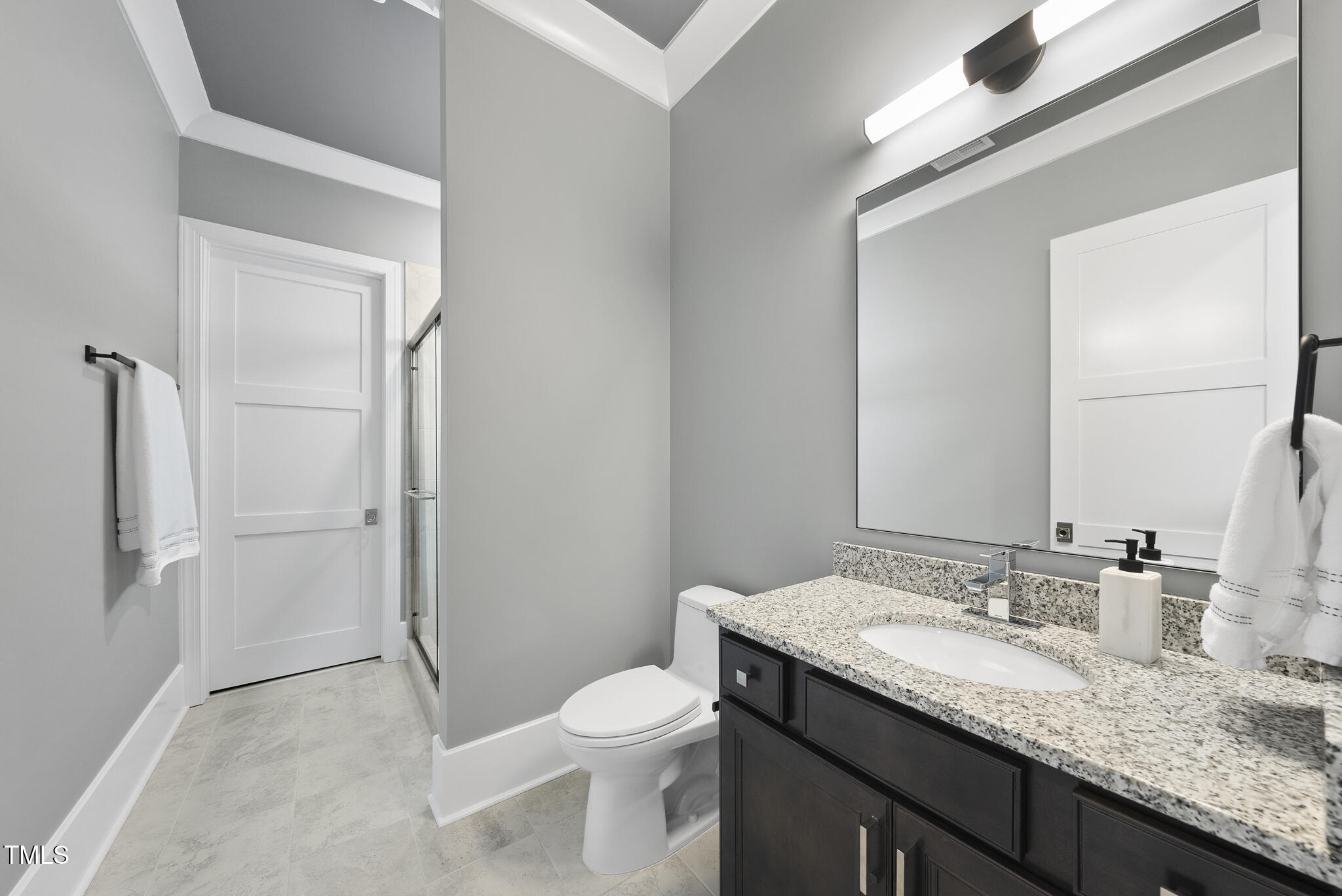 129 Damsire Way Cary, NC 27513 - Photo 26 of 33 a bathroom with a granite countertop sink toilet and shower