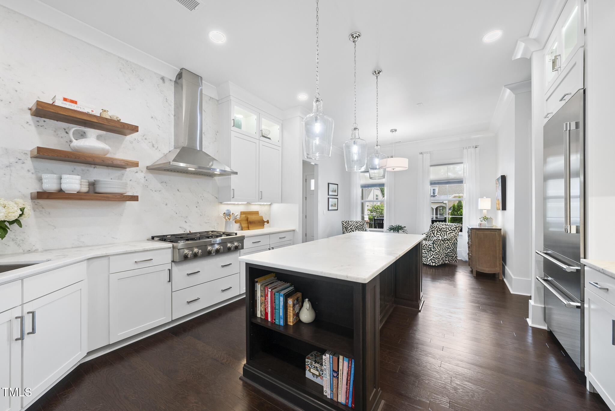 129 Damsire Way Cary, NC 27513 - Photo 8 of 33 a large kitchen with stainless steel appliances kitchen island granite countertop a large stove a sink dishwasher and a refrigerator with wooden floor