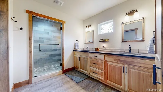 a bathroom with a double vanity sink and mirror