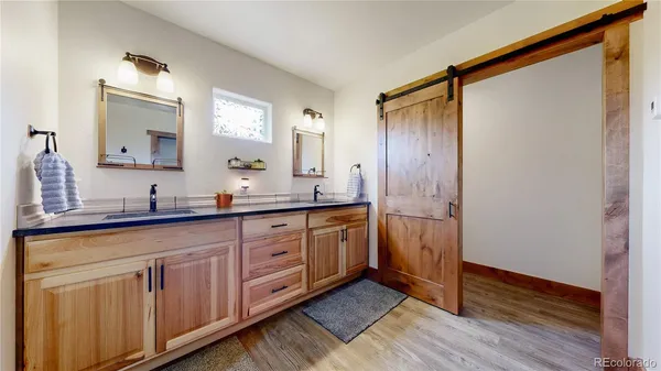 a spacious bathroom with a double vanity sink and a mirror