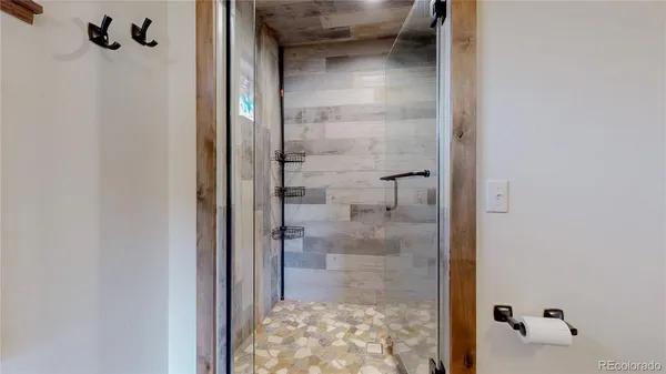 a bathroom with a glass shower door