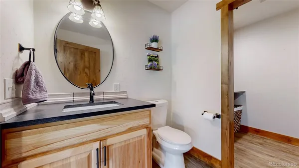 a bathroom with a toilet sink and mirror