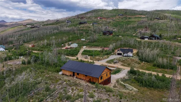 an aerial view of a house with river lake view and mountain view